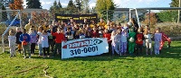 Rugby Hornets kids holding a Panago sign and rugby balls