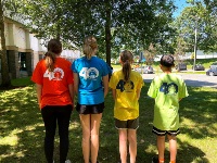 Four leaders in training from the back showing the 40 year t-shirts logo