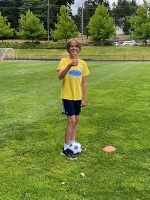 Leader in training at the soccer field with a soccer ball